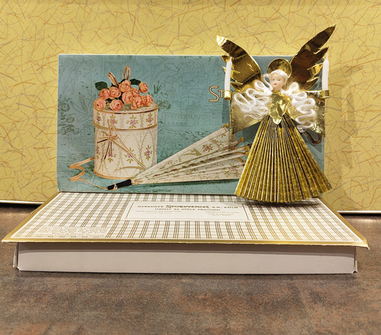 Vintage Wachsengel aus Aluminium in Stollwerk Pralinen Verpackung 1960er